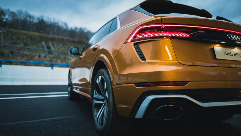 Rear view of a parked Audi RS Q8 SUV highlighting its shiny taillights and emblem.